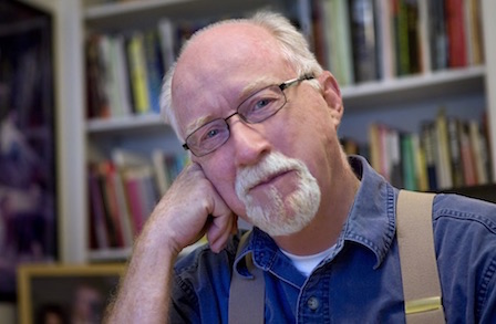 Headshot of poet William Trowbridge in front of a bookshelf.
